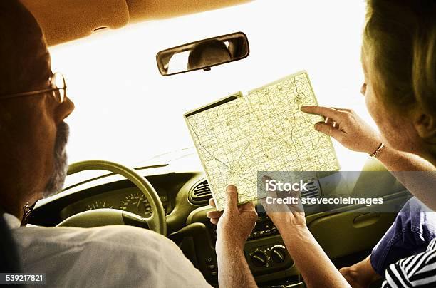 Couple Looking At A Road Map While Traveling On Vacation Stock Photo - Download Image Now