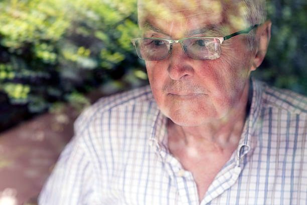 istock Elderly weak man looking through the hospital window 539217942