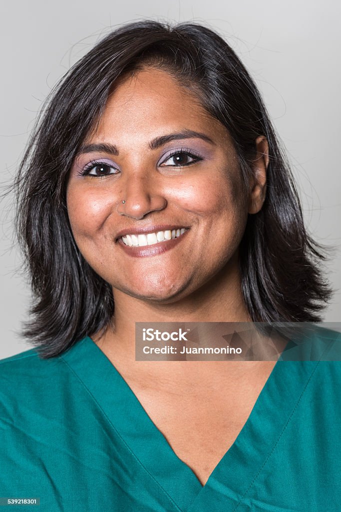 Indian mid adult woman Smiling Indian mid adult woman looking at the camera on gray background 30-39 Years Stock Photo