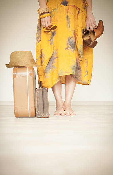istock Woman standing beside suitcases 539218722