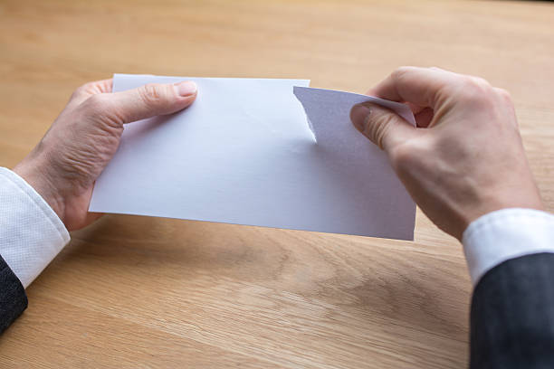 istock businessman tearing paper by scissors 539218784