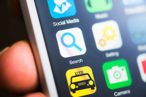 istock Hand holding phone, search app on screen 539220354