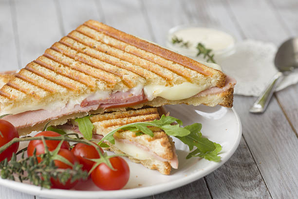 istock Sandwich with ham and tomatoes on wood background 539221730