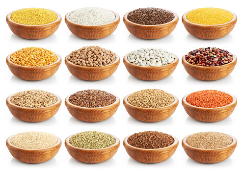 Wooden bowl with porridge, cereals, lentils, peas and beans isolated on white background. Collection.