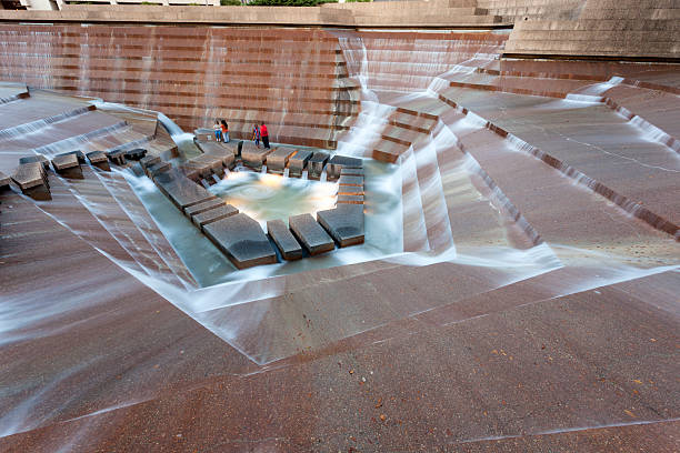 Fort Worth, TX, USA - April 6, 2016: Visitors enjoying fresh air at the bottom of Water Gardens in the city of Fort Worth.
