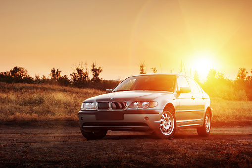 Saratov, Russia - August 20, 2014 - Car BMW E46 standing at countryside dirt road at sunset