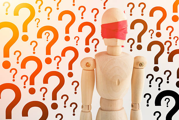 istock wood  figure blind with red ribbon with question mark 539224604