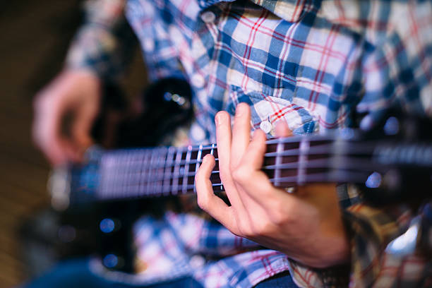 istock Bass player holding guitar neck focus 539224796