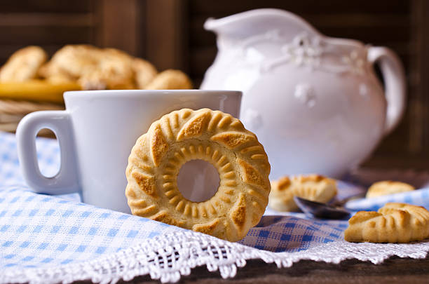 Round cookies with an ornament on a dark wooden background. Selective focus.