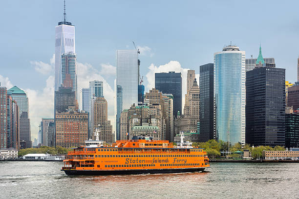 New York, USA - Apr 28, 2016: Staten Island Ferry on the New York Harbor against of Lower Manhattan skyscrapers