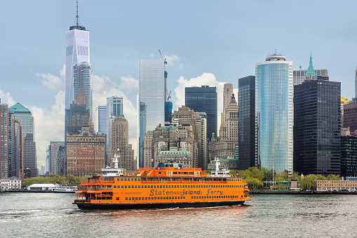 New York, USA - Apr 28, 2016: Staten Island Ferry on the New York Harbor against of Lower Manhattan skyscrapers