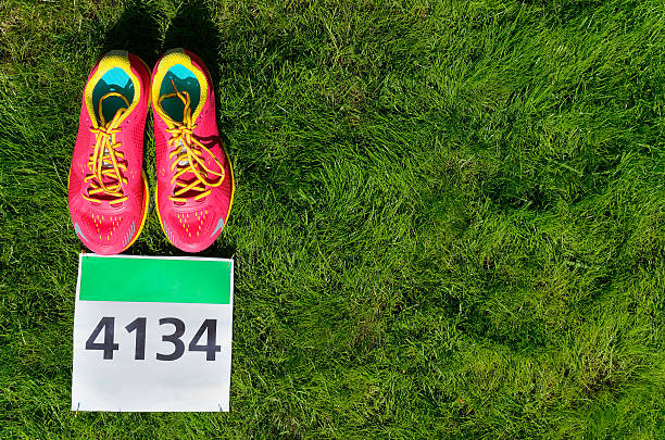 istock Running shoes and marathon race bib (number) on grass 539225840