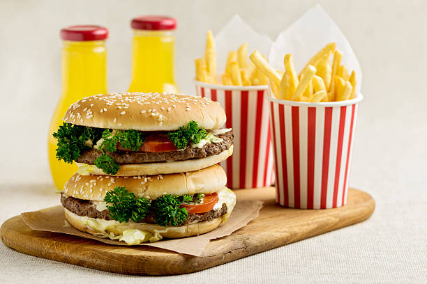 istock Burger with beef, tomato and herbs. Fries and juice. 539225984