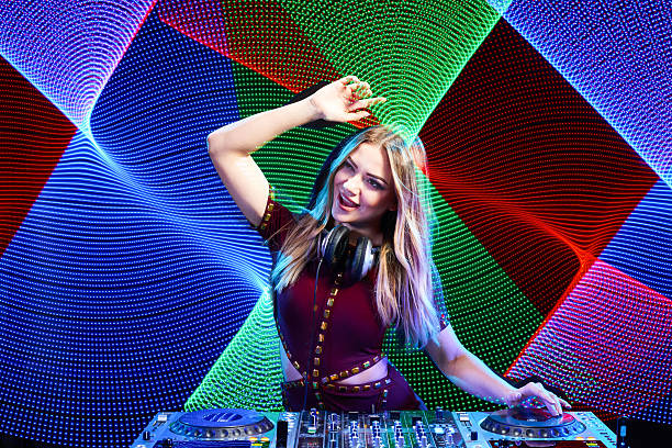 istock DJ girl on decks at the party 539226160