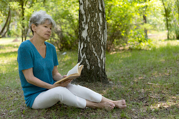 istock Senior woman reading a book 539227780