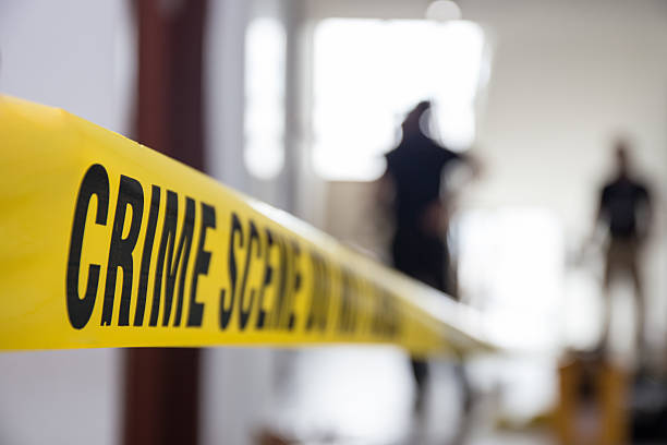 istock crime scene tape in building with blurred forensic team 539228200