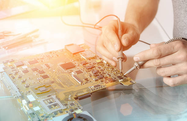 istock Hands of male tech testing motherboard 539228638