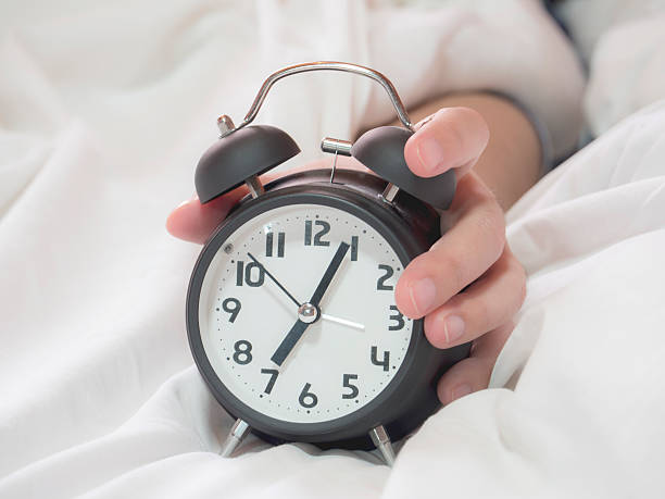 istock Close up hold alarm clock 1 539229796