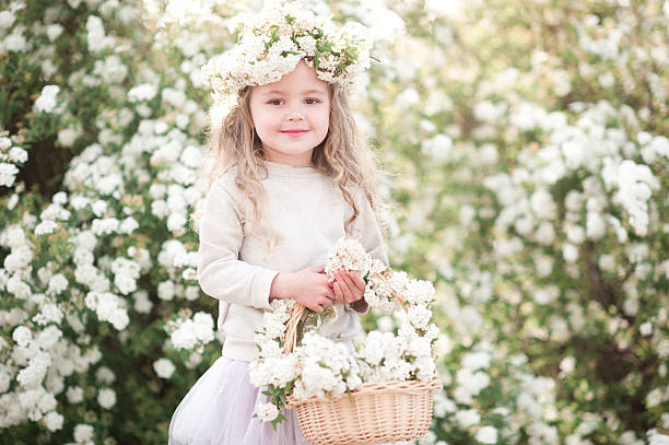 istock Blonde kid girl with flowers 539230332