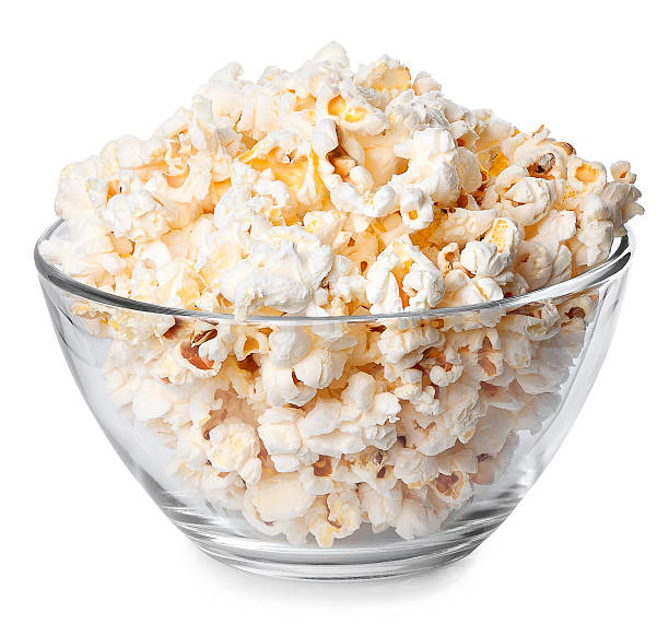 Glass bowl with popcorn isolated on white background Glass bowl full of popcorn isolated on white background. Popcorn. Bowl of fresh popped popcorn. Bowl of popcorn popcorn snack bowl isolated stock pictures, royalty-free photos & images