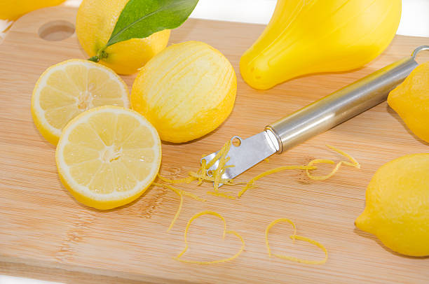 istock Lemons, squeezer, zest and Zester on wooden cutting board. 539231034