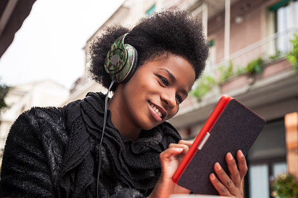 istock Woman reading an e-book seated on a cafe 539233031