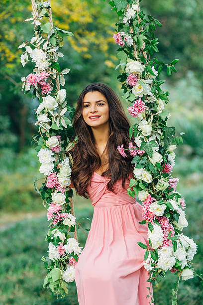 istock Beautiful young girl on a swing 539233099