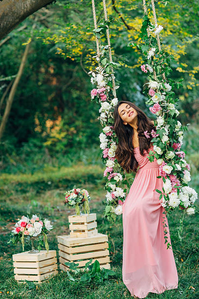 istock Beautiful young girl on a swing 539233121