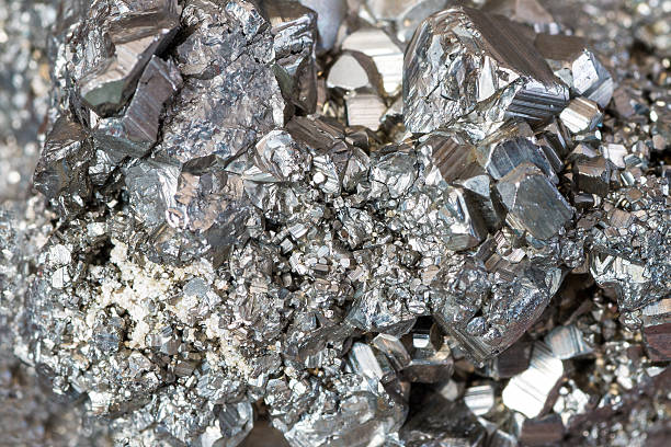 Auriferous Pyrite (Fe S2) gray stone crystals background stock photo