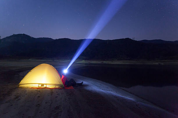 istock Young man Standing  night sky and beam of light 539233695