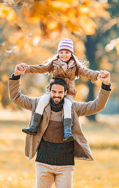 istock Father and daughter having fun in autumn. 539233893