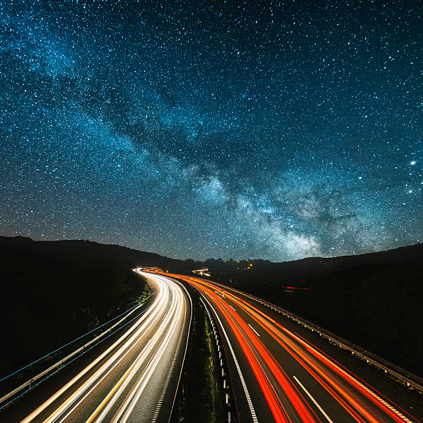 Highway at night Highway lights under the milky way milky way photos stock pictures, royalty-free photos & images