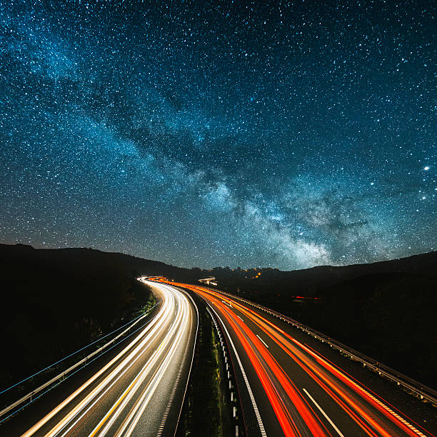 Highway at night Highway lights under the milky way car light stock pictures, royalty-free photos & images