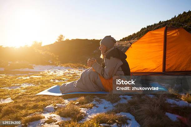 Girl Sitting In A Sleeping Bag Stock Photo - Download Image Now - Activity, Adventure, Arts Culture and Entertainment