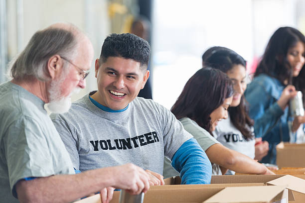 istock Diverse volunteers soritng food bank donations into boxes 539234217