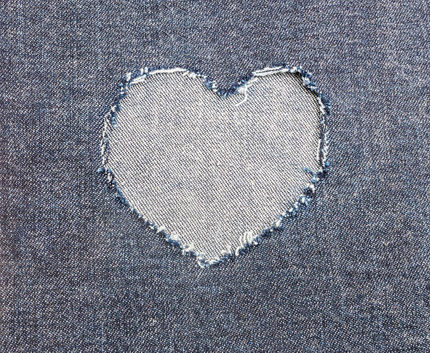 istock Heart shape ripped jean for Valentine's card background 539234332