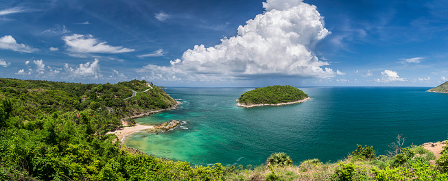 Panoramic view of the secluded beach of Ya Nui on the island of Phuket in Thailand. Phuket is world wide famous tourist destination for its pristine clear water and white sand beaches along its west coast.