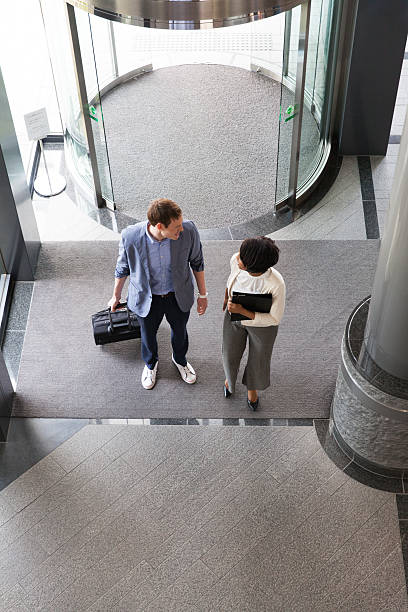 istock business people entering into the lobby 539234860