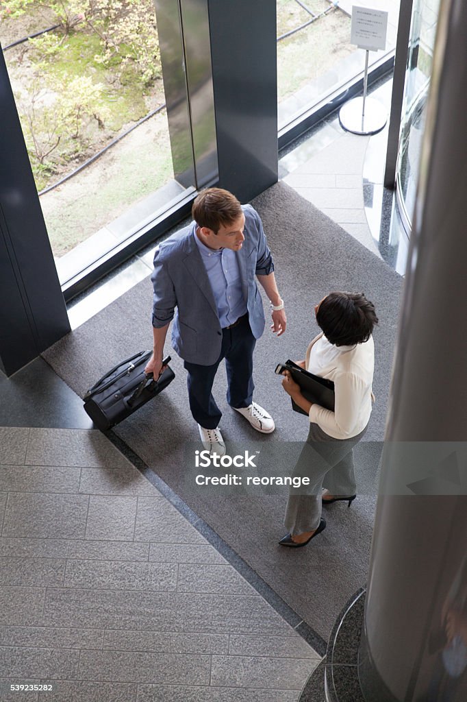 business people entering into the lobby Adult Stock Photo