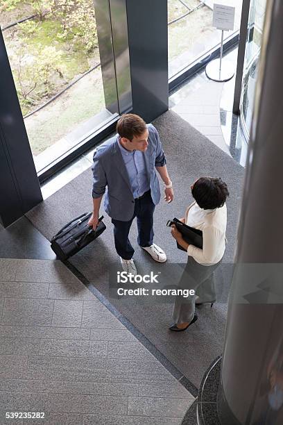 Business People Entering Into The Lobby Stock Photo - Download Image Now - Adult, African Ethnicity, African-American Ethnicity