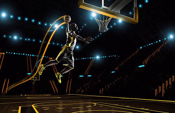 Futuristic basketball Basketball player from far future is going to make slam dunk on a indoor futuristic stadium basketball sport stock pictures, royalty-free photos & images