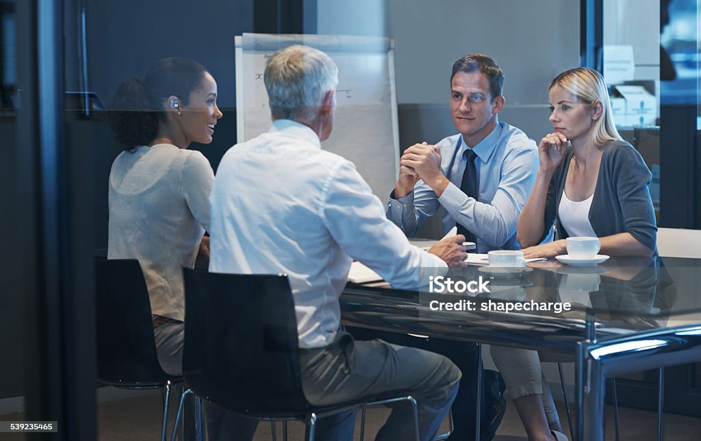 Perfect alliance A group of businesspeople having a meeting Contemplation Stock Photo