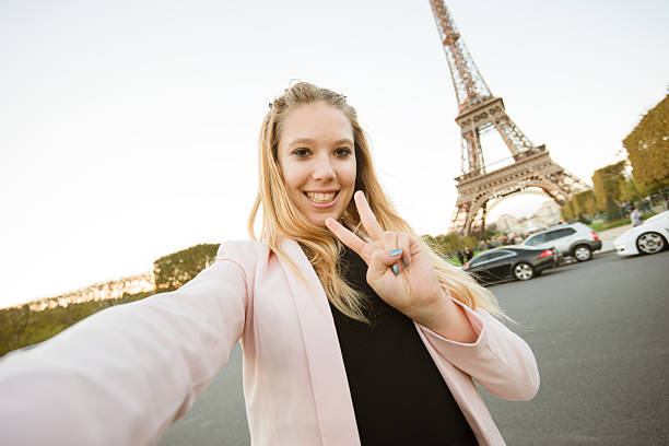 istock woman self photographing on paris ith the tour eiffel 539235495