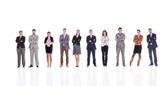 Large group of smiling business people standing with their arms crossed and looking at the camera. Isolated on white.