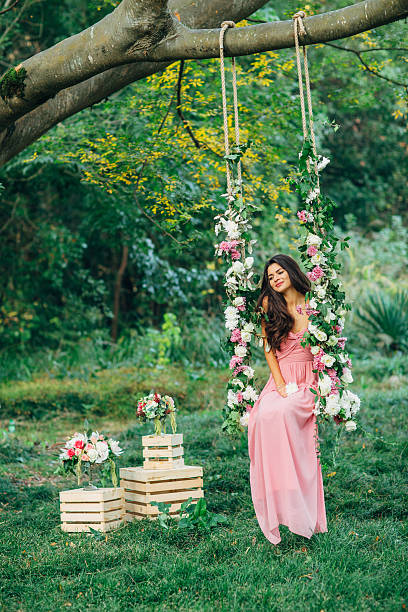 istock Beautiful young girl on a swing 539235709