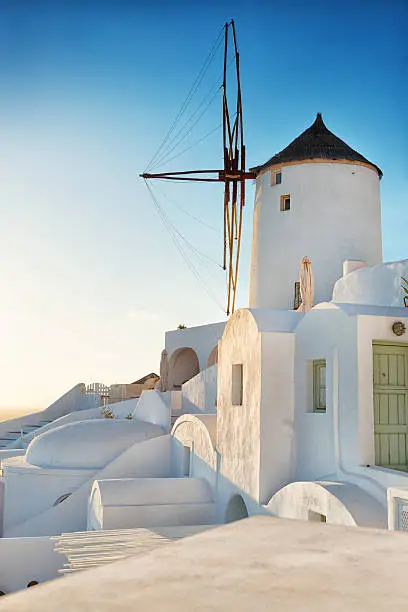 Traditional Windmill in Greek island of Santorini on Sunset. A windmill at Oia on the Greek island of Santorini.