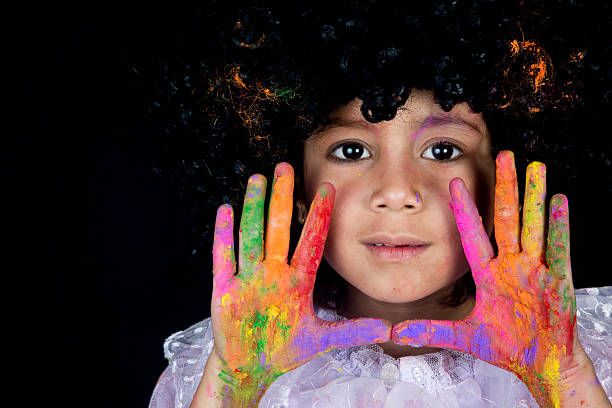 istock Small girl showing vibrant colored hands and smiling 539236391