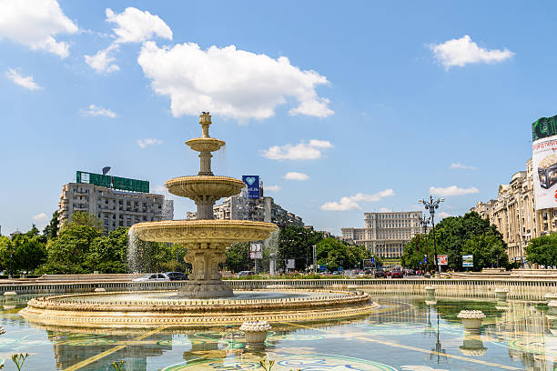 Union Square Fountain And Parliament Palace In Bucharest Bucharest, Romania - May 28, 2016: Union Square Fountain And House Of The People Or Parliament Palace (Casa Poporului) View From Union Boulevard (Bulevardul Unirii) In Downtown Bucharest. parliament palace in bucharest romania the largest building in europe stock pictures, royalty-free photos & images