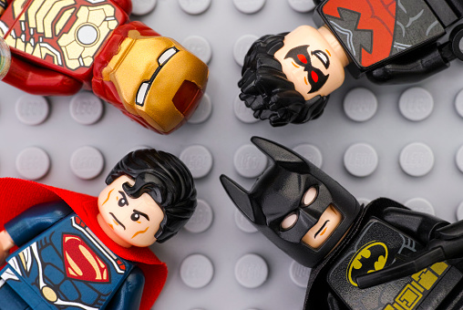 Tambov, Russian Federation - May 12, 2016: Four Lego Super Heroes - Iron Man, Batman, Superman, Nightwing - minifigures on Lego gray baseplate background. Studio shot.