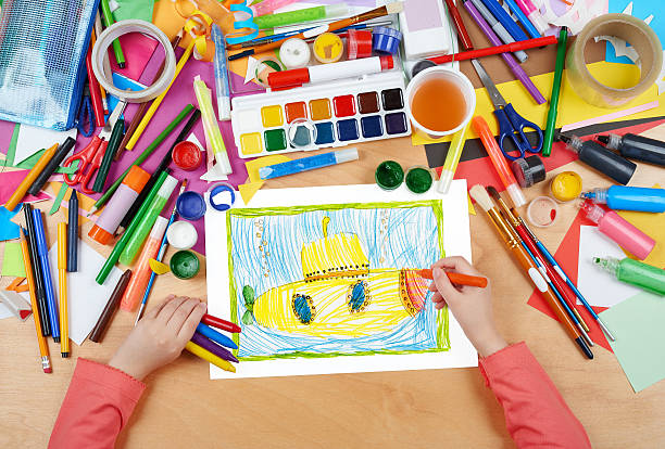 istock yellow submarine underwater child drawing, top view hands 539238922
